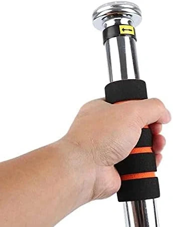 A close-up of a hand gripping the handle of a silver metal pole with black foam grip sections and orange accent stripes, isolated on a white background.