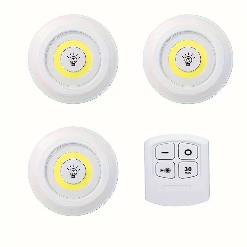Four white round smart home light sensors with a yellow LED light panel and a white remote control, arranged on a plain white background.