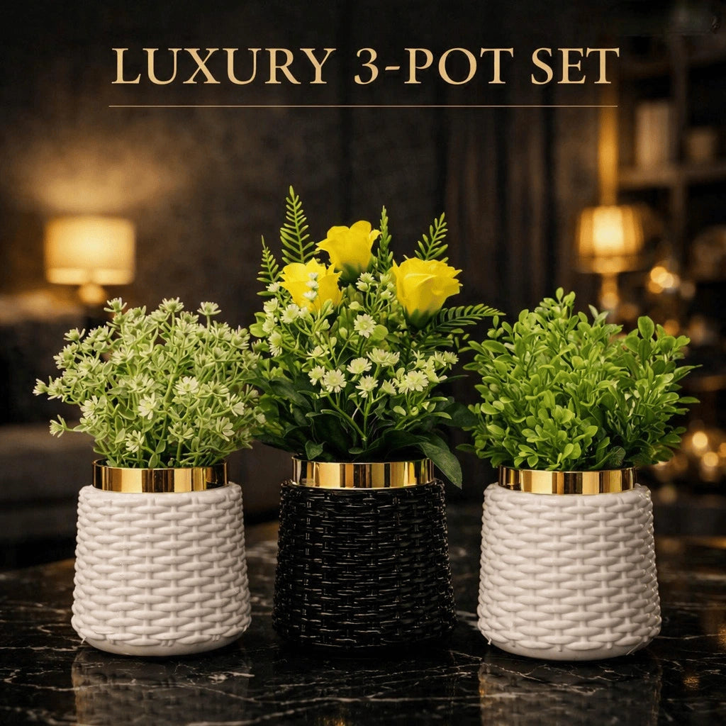Three artificial flower pots arranged together on a dark marble surface, with the text 'LUXURY 3-POT SET' above them. The pots are woven in off-white, black, and off-white, with gold trim, holding green and yellow faux plants.