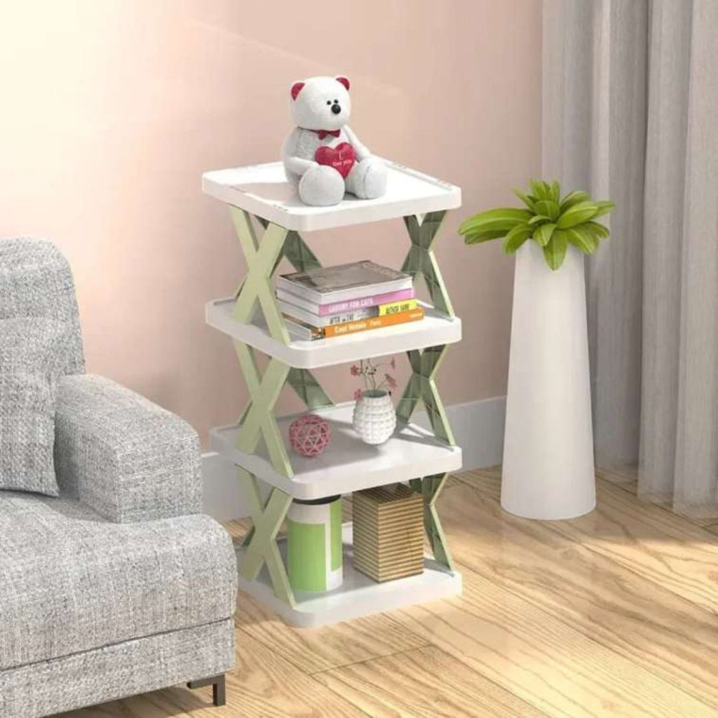 White and green side table with books and a teddy bear in a room setting.