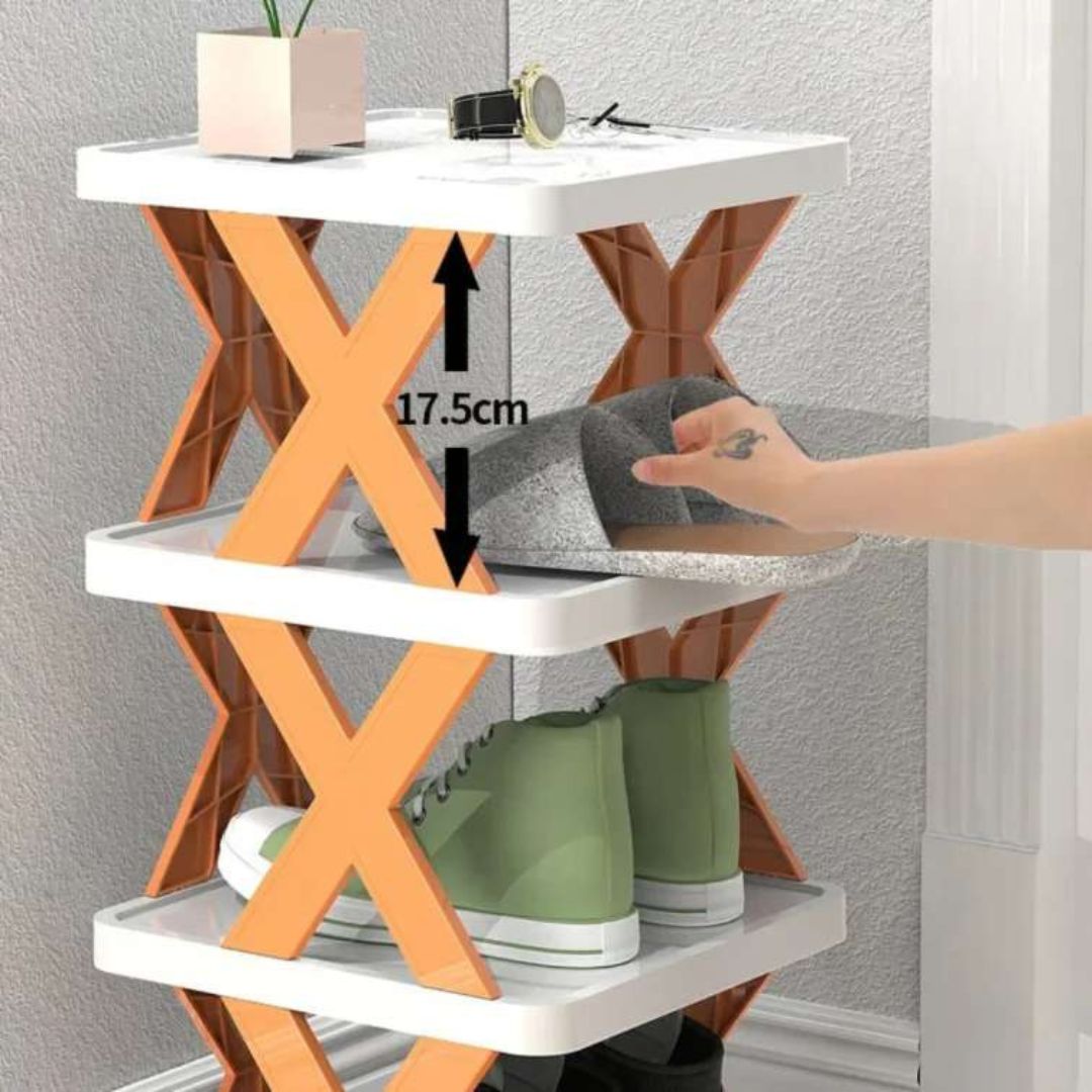 Three-tiered shoe rack with wooden frame and white shelves, showing a hand placing shoes on the bottom shelf.