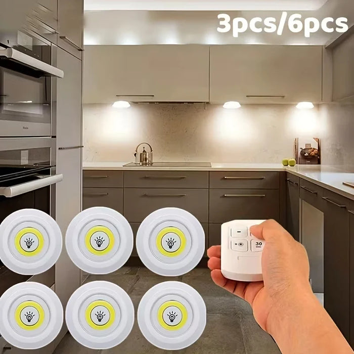Hand holding a light switch with six wall-mounted light bulbs in a kitchen setting.