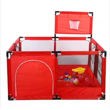 Red playpen with basketball hoop and toys inside on a white background
